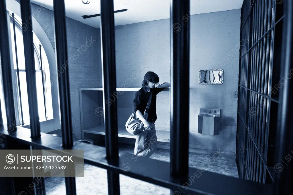 Young man behind bars