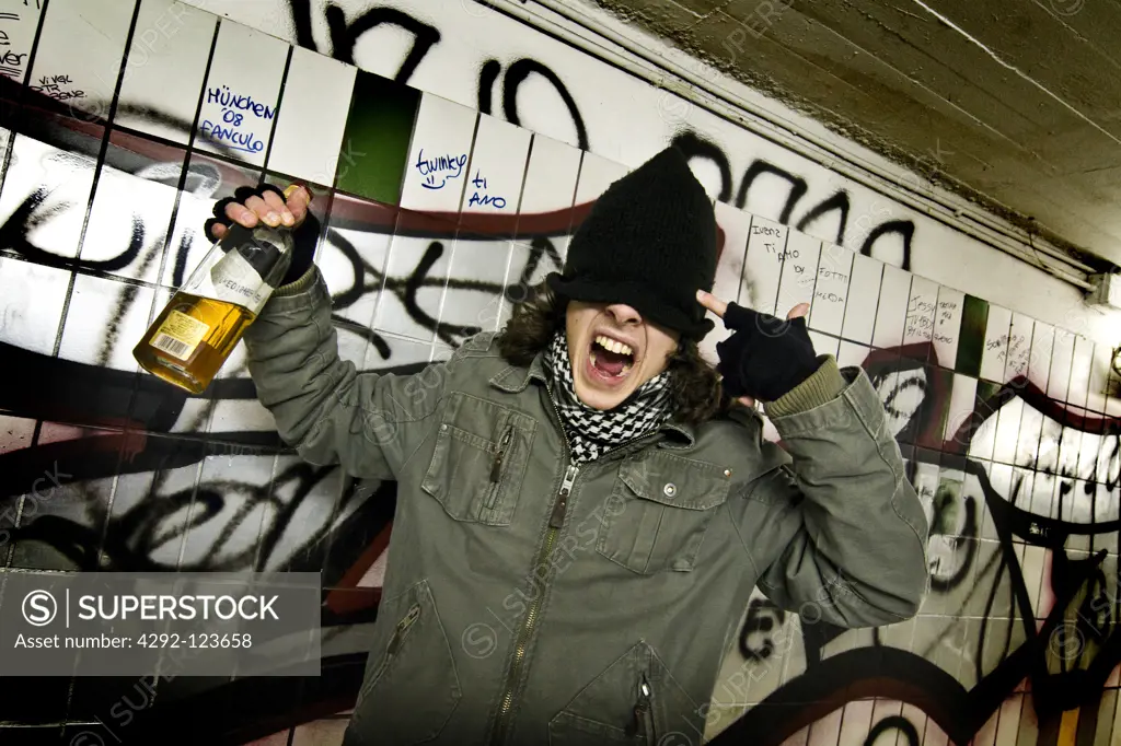Teenage boy with whisky bottle