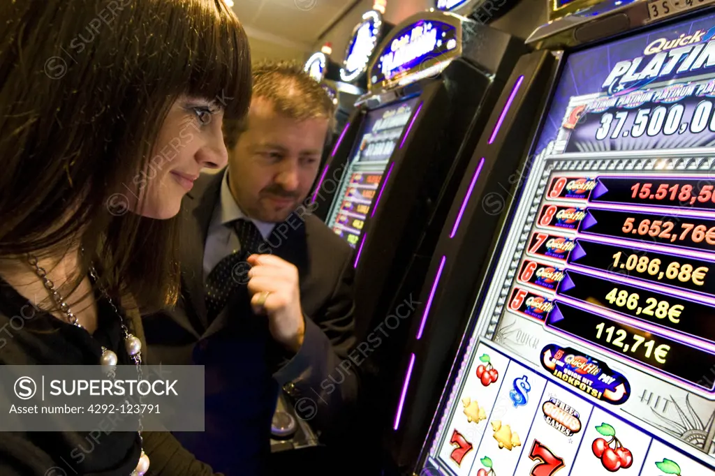 Italy, Val D'Aosta, Saint Vincent, people at slot machine