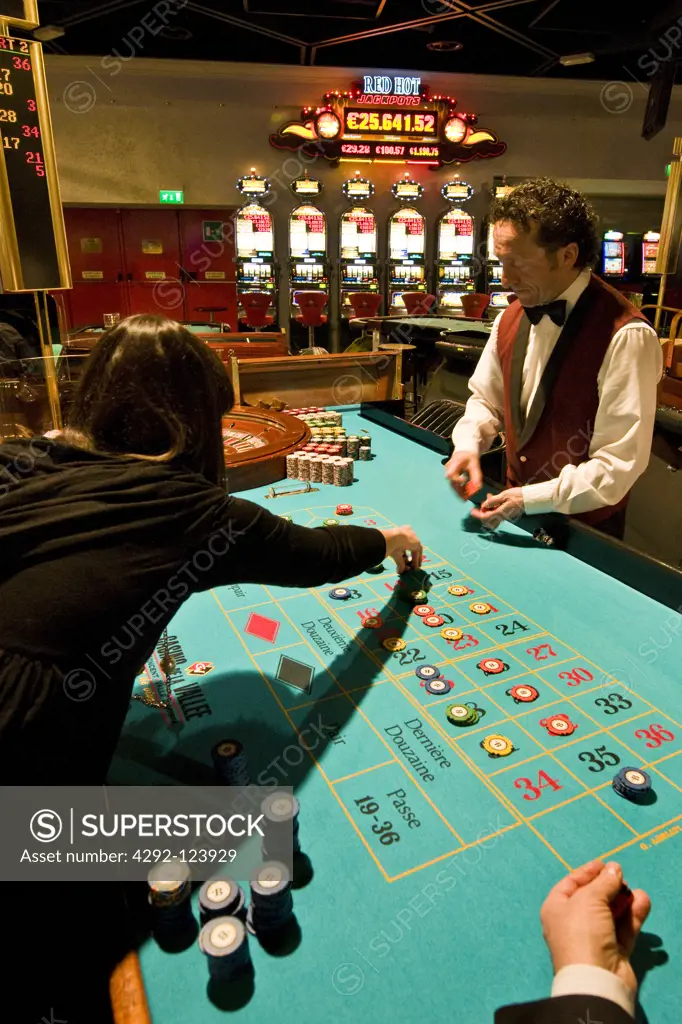 Italy, Val D'Aosta, Saint Vincent, people gambling at roulette table in casino