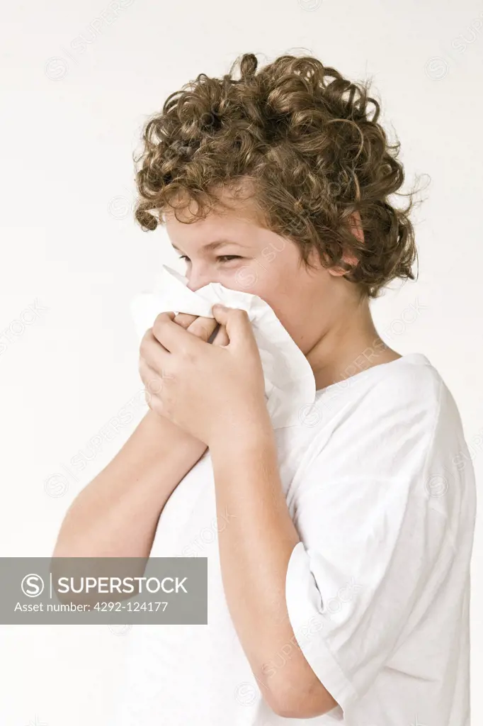 Boy blowing nose