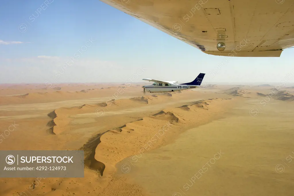 Africa, Namibia, aerial view of the desert and Cessna 210 airplane