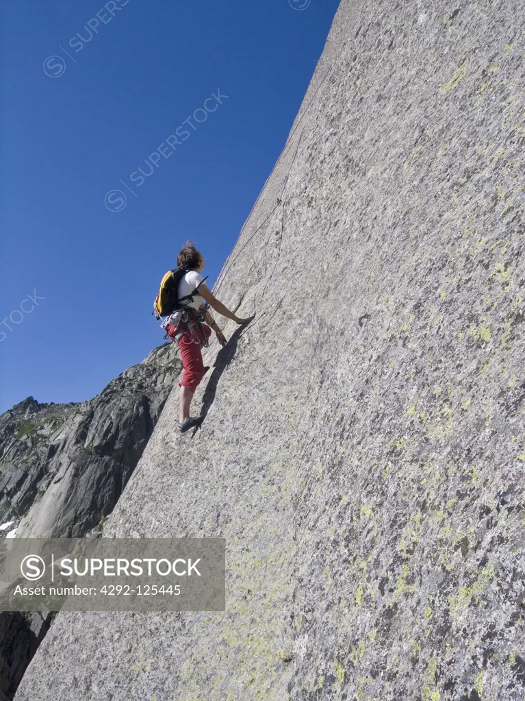 France, Corsica, Restonica Valley Symphonie d'automne, man climbing rock