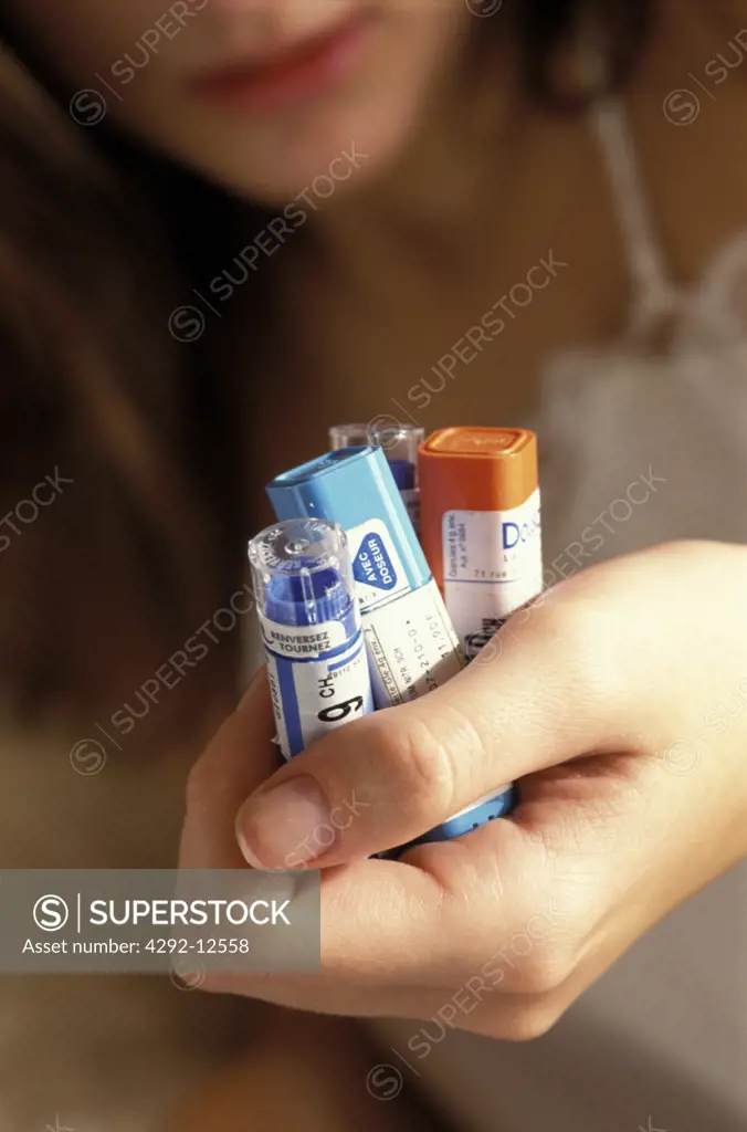 woman holding homeopatic remedies