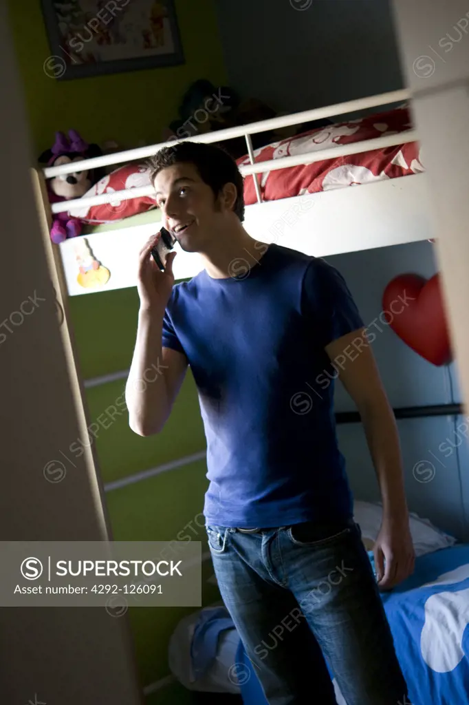 Teenage boy at home talking on mobile