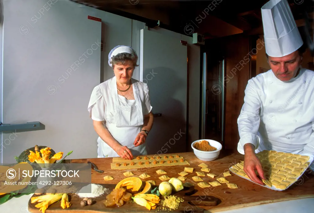 Italy, Lombardy, Mantova, man and woman in restaurant making tortelli di zucca
