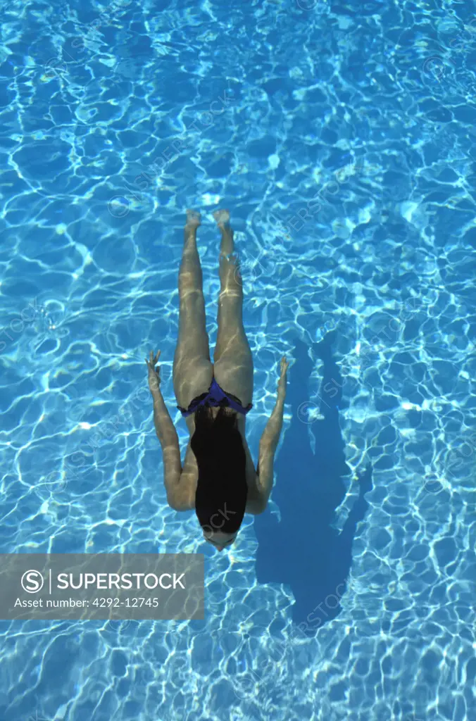 Woman with long hair swimming
