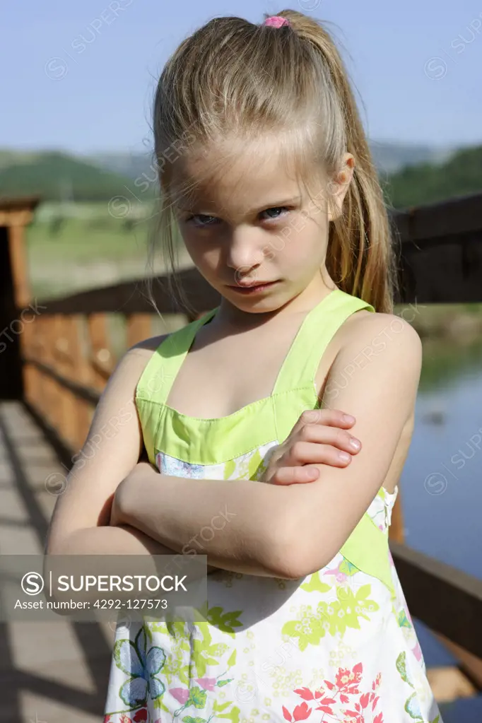 Portrait of angry girl with arms crossed