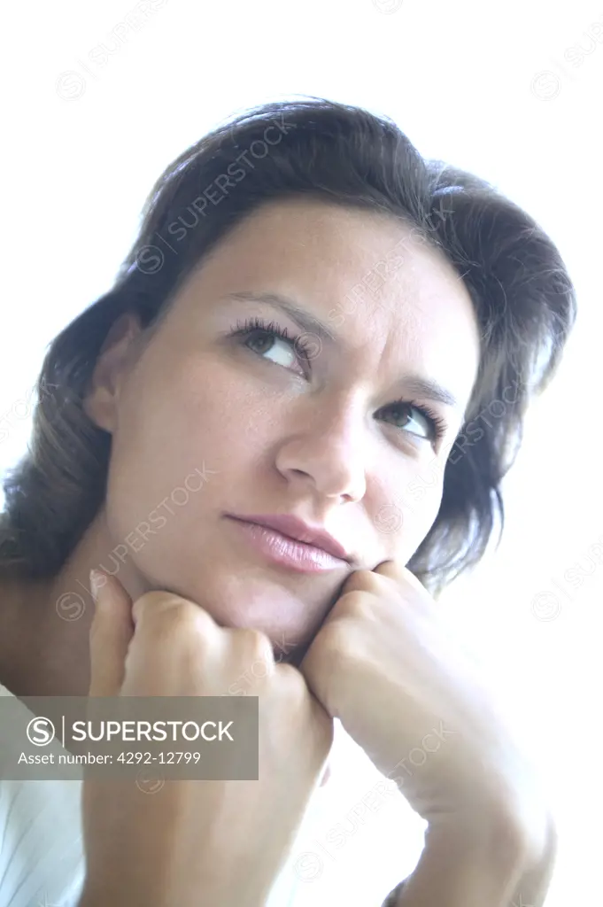 Portrait close up of a young thinking woman, disappointed