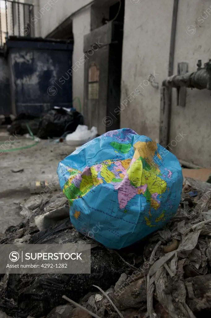 Deflated World Globe Balloon in Garbage