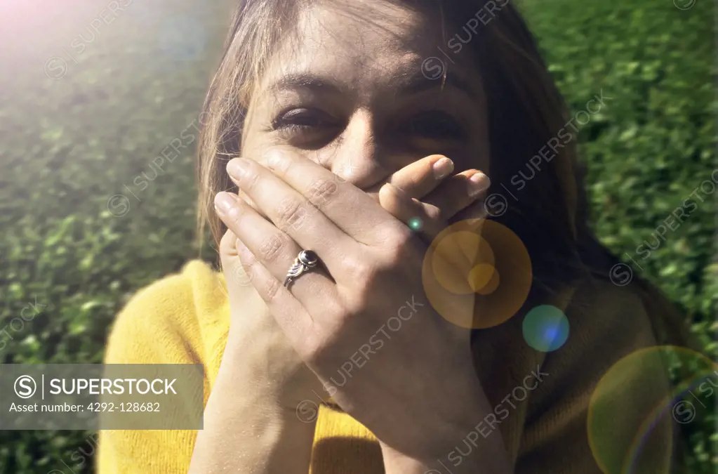 Portrit of woman covering mouth with hands