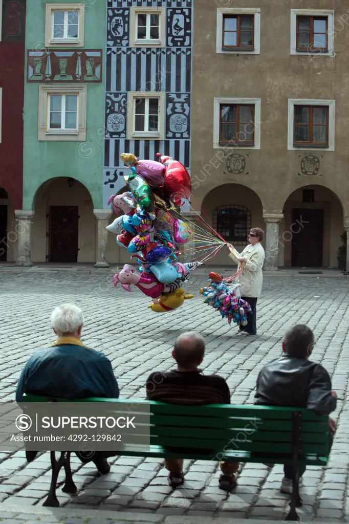 A balloon shop assistant in the Stary Rynek place in the starlings Miasto or Old Town in centre of Poznan or poses in great Pole in Poland.