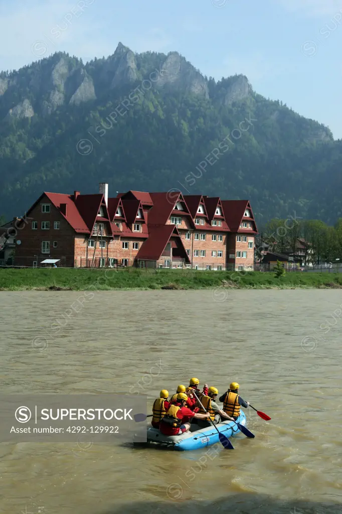 Rubber dinghy driver on the river Dunajec in Cerveny Klastor on the border to Poland with sicht on the scenery on the polnichen side in the north of Slovakia.