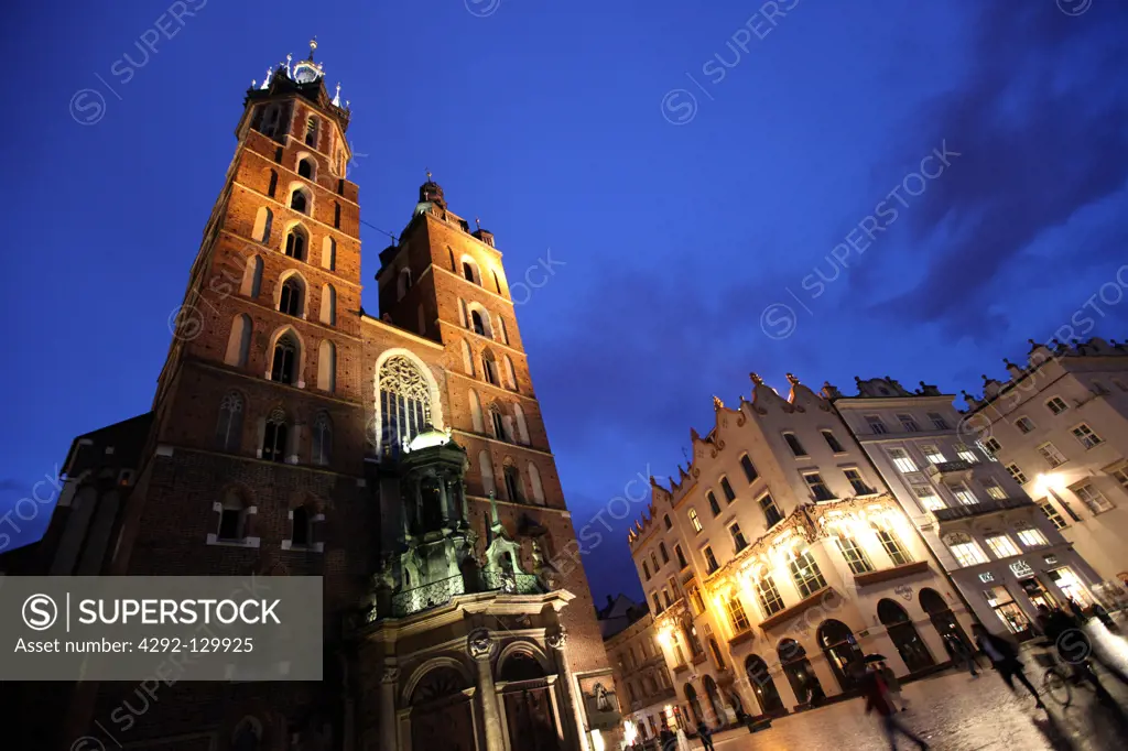 The Rynek Glowny place with the Marien's church in the starlings Miasto or Old Town of Cracow in Poland.