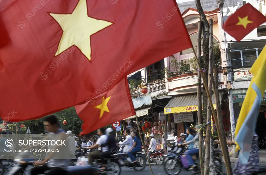 Vietnamese flags with a flag stand in the part of town of Cholon in Saigon in sueden from Vietnam in southeast Asia.