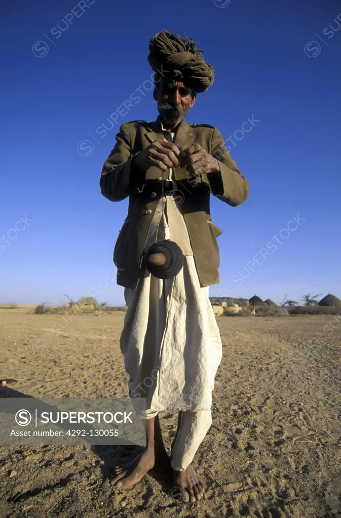 A man in the wild city of Jaisalmer in the Tar desert in the province of Rajasthan in west India in India.