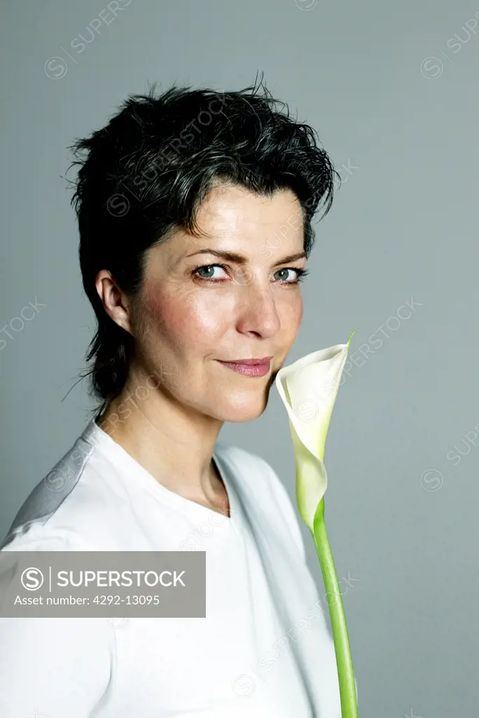 Portrait of woman over forty with flower