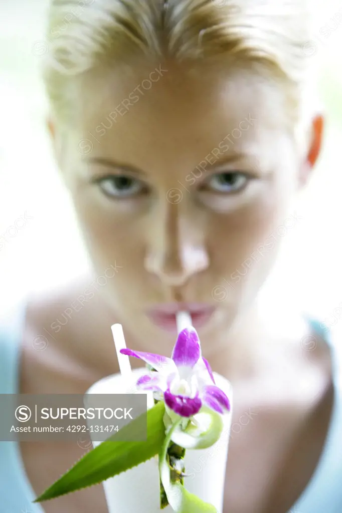young blond woman enjoy some drink in summer holiday, portrait