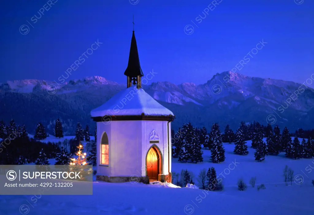 Chapel, christmastree, alps in winter