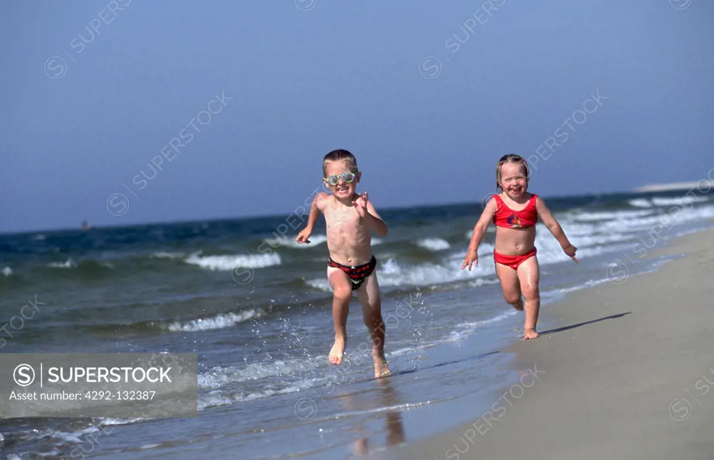 Boy and Girl Playing on the Beach.