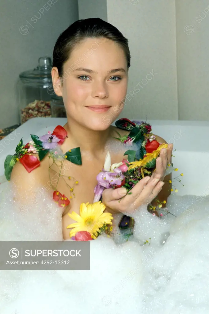 Woman having bath with flowers