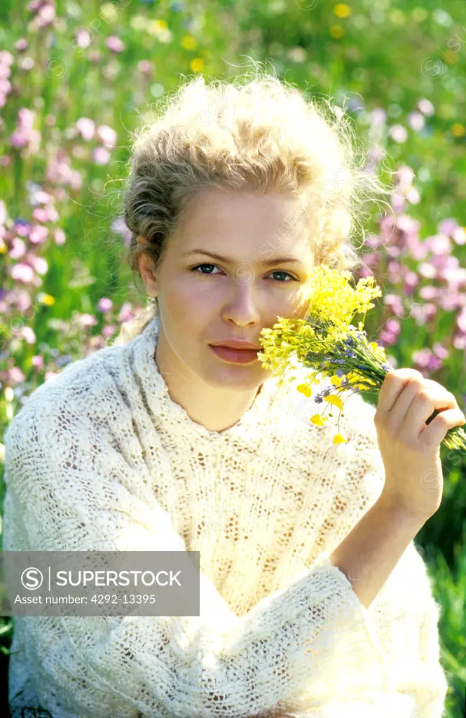 Portrait of blond woman with wildflowers