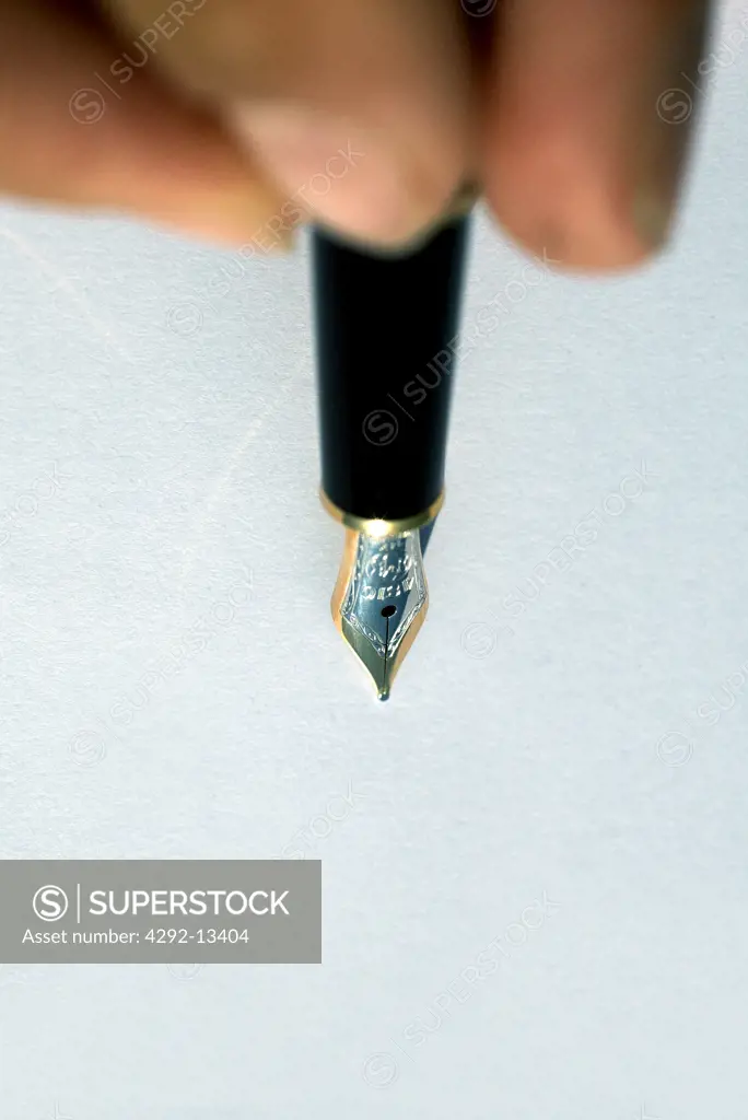 Fingers holding fountain pen