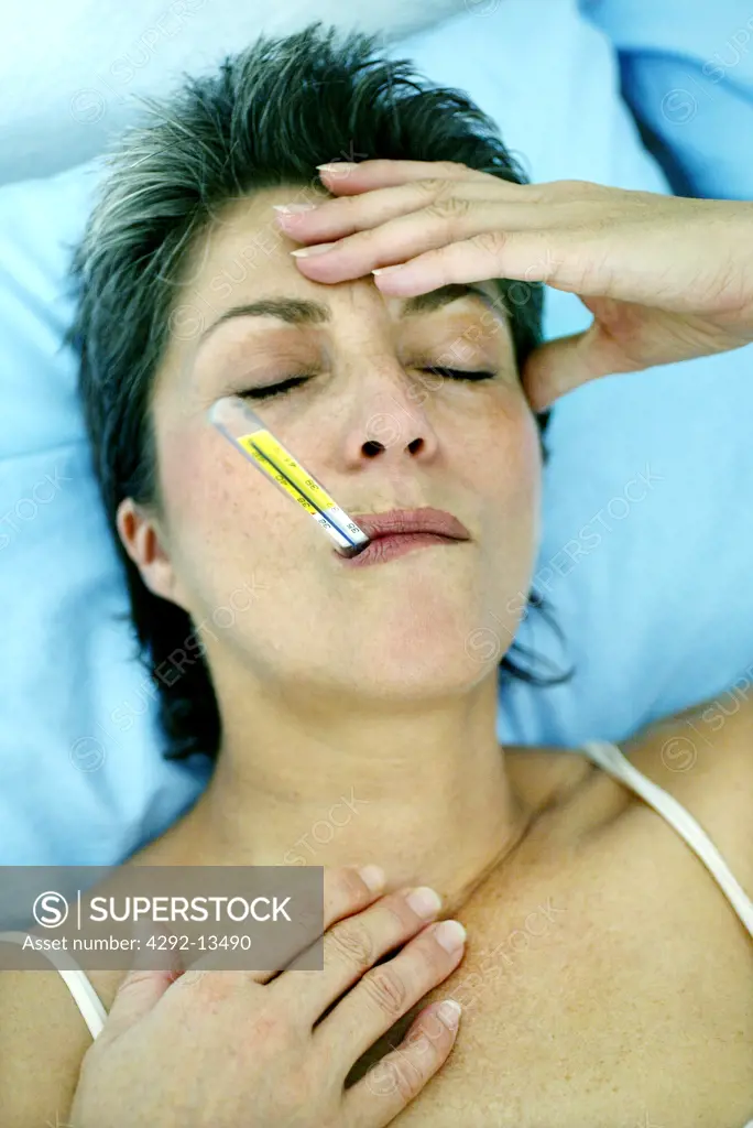 Woman over forty with thermometer in mouth