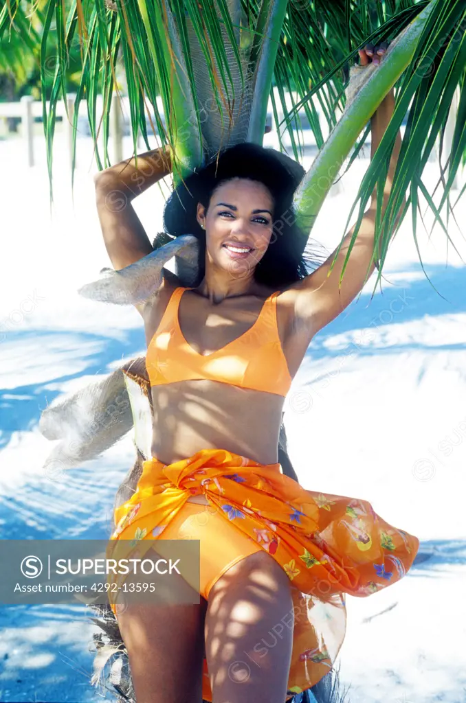 Woman under palm tree
