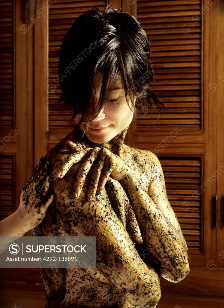 Asian woman under scrub treatment