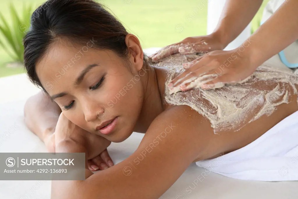 Asian woman under scrub treatment