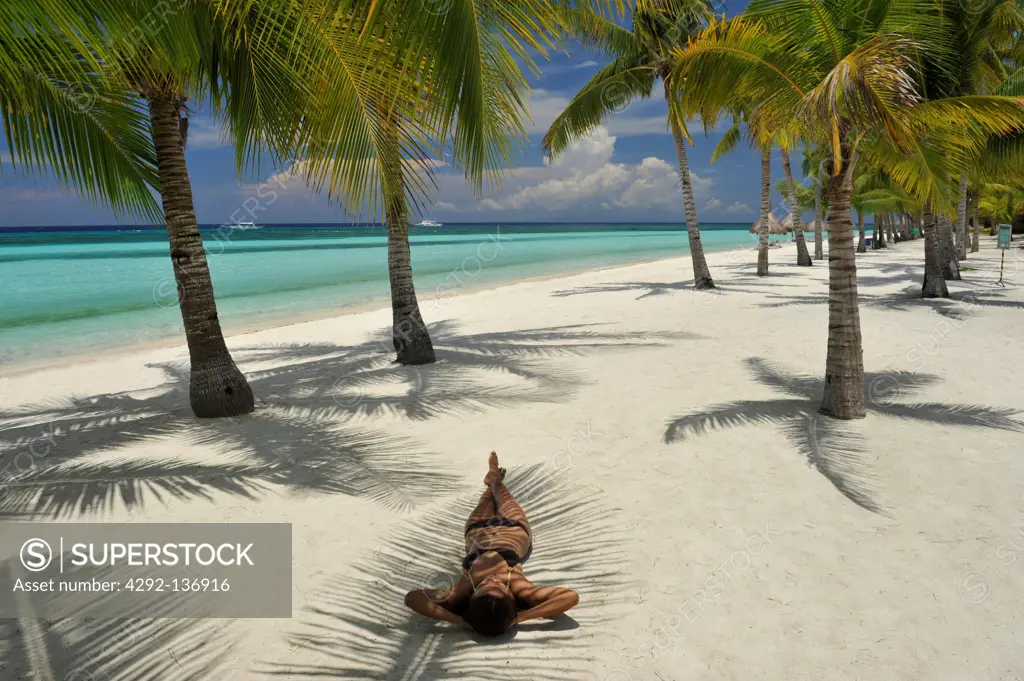 Asia, Philippines, Bohol, woman sunbathing on the beach