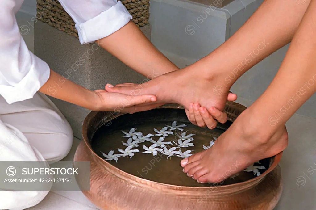 Woman getting a floral foot bath