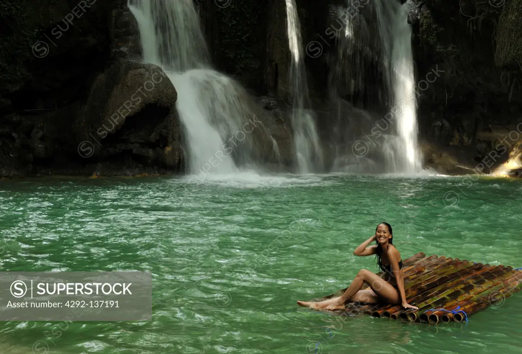 Asia, Philippines, Mag aso, woman in a pond with waterfall