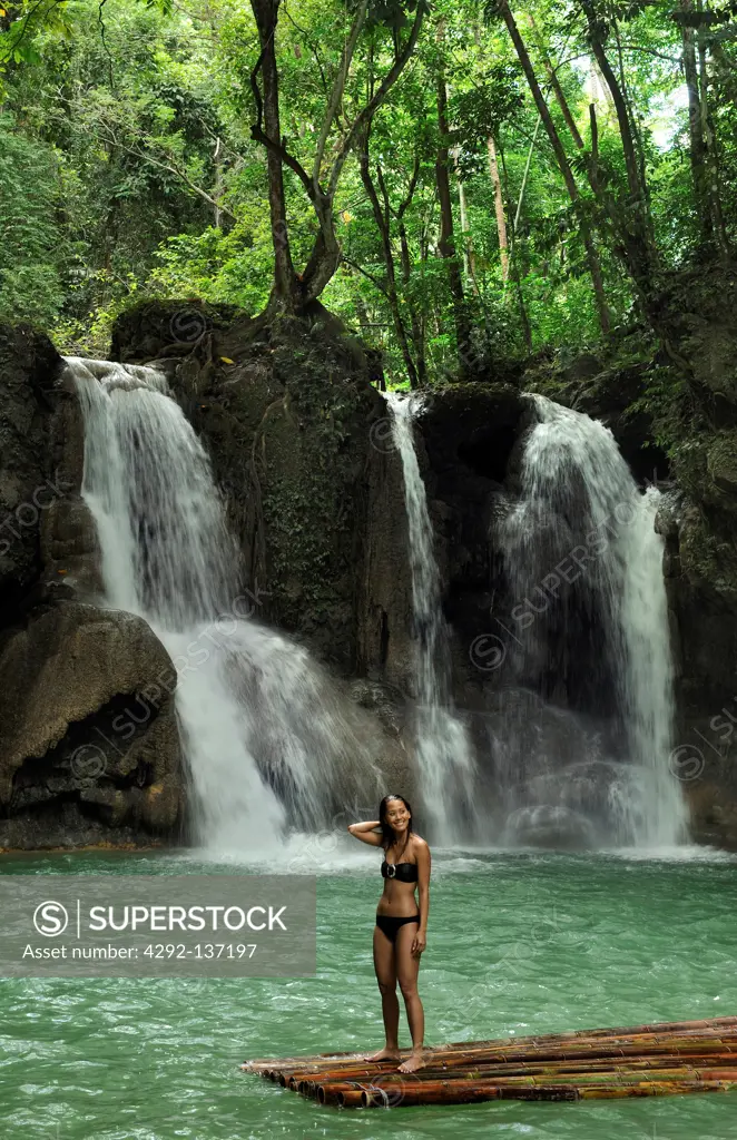 Asia, Philippines, Mag aso, woman in a pond with waterfall