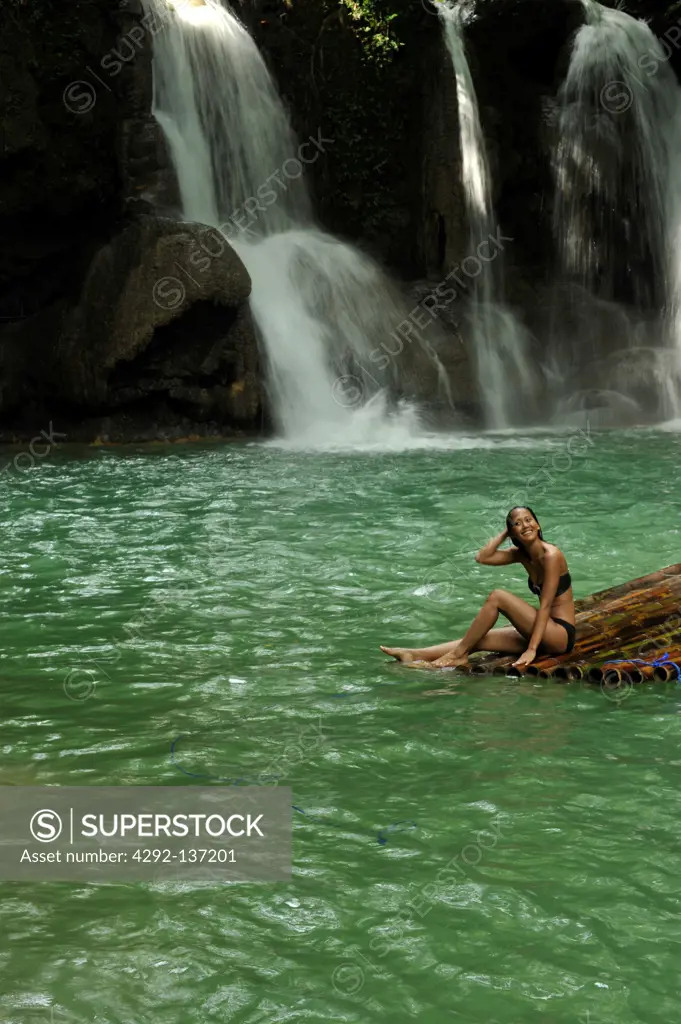 Asia, Philippines, Mag aso, woman in a pond with waterfall