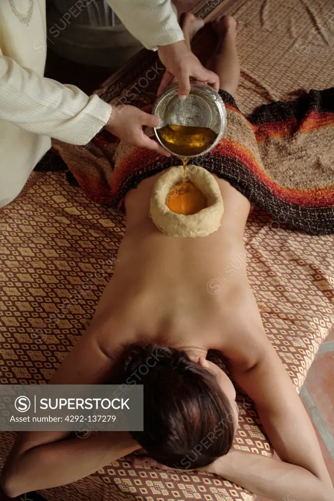 Woman having Kathi Basti, an ayurvedic treatment