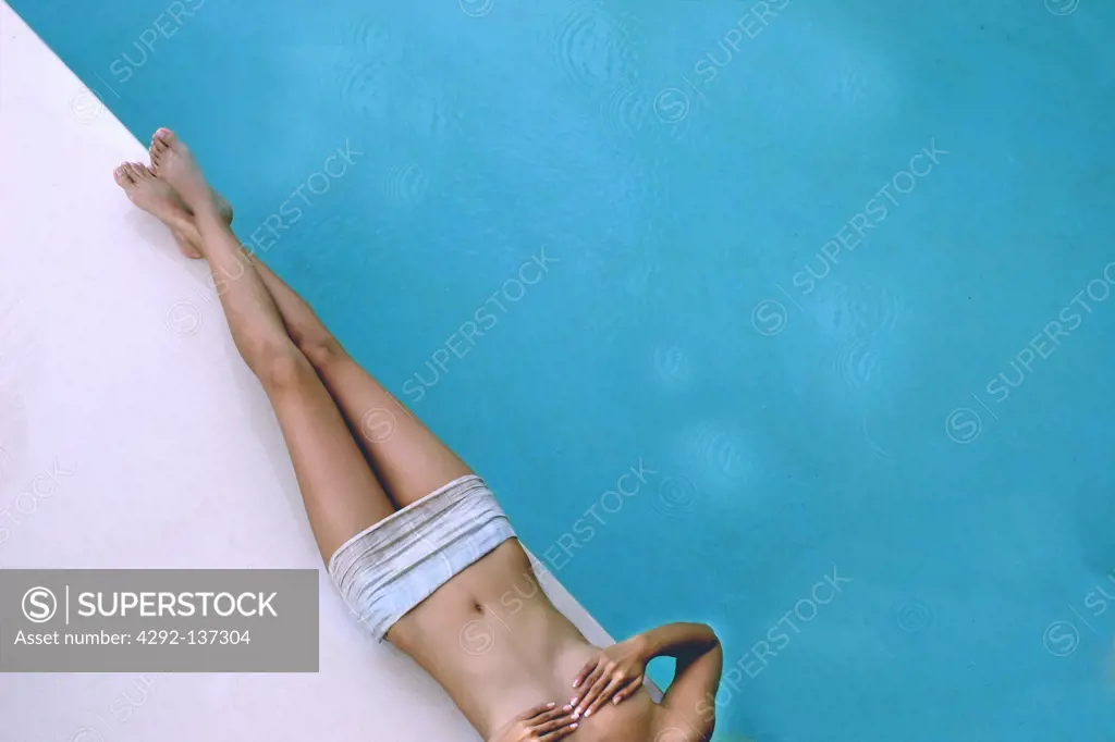 Woman lying at swimming pool
