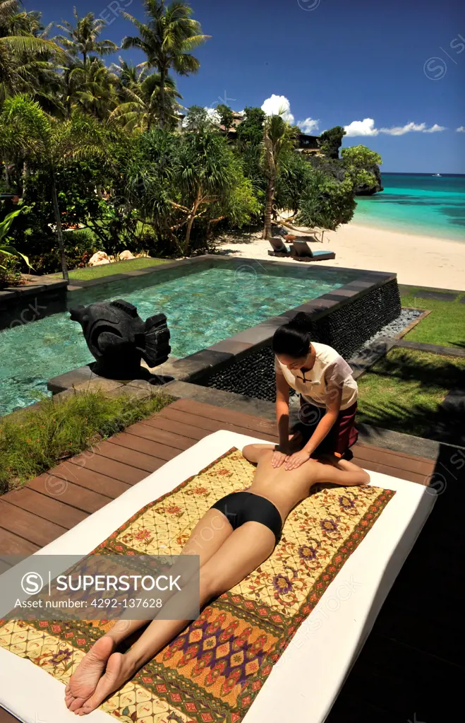Asia, Philippines, Boracay, Shangri La hotel, woman getting a massage on the pool by the beach