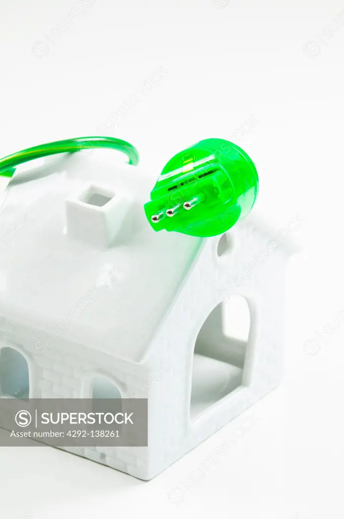 house and Green electrical plug and socket