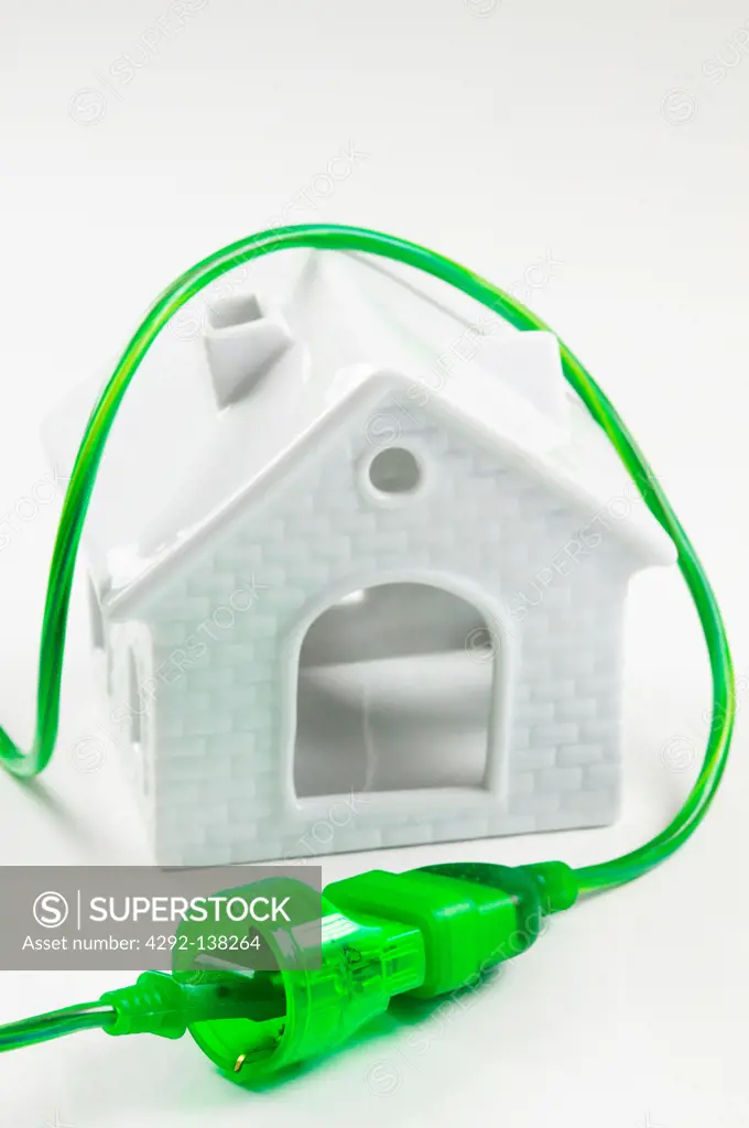 house and Green electrical plug and socket