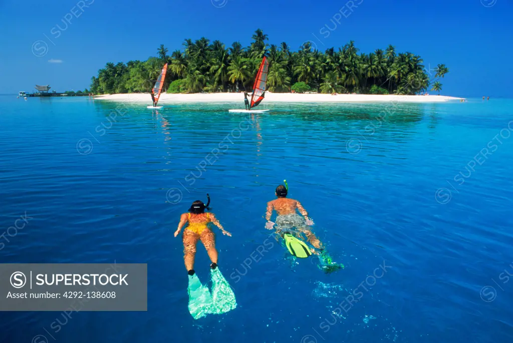 Couple snorkeling off Fihalhohi Island, Maldives