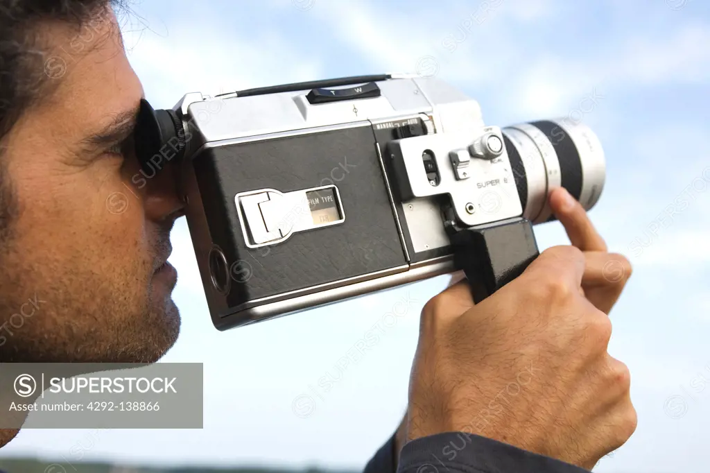 Man with old 8mm movie camera