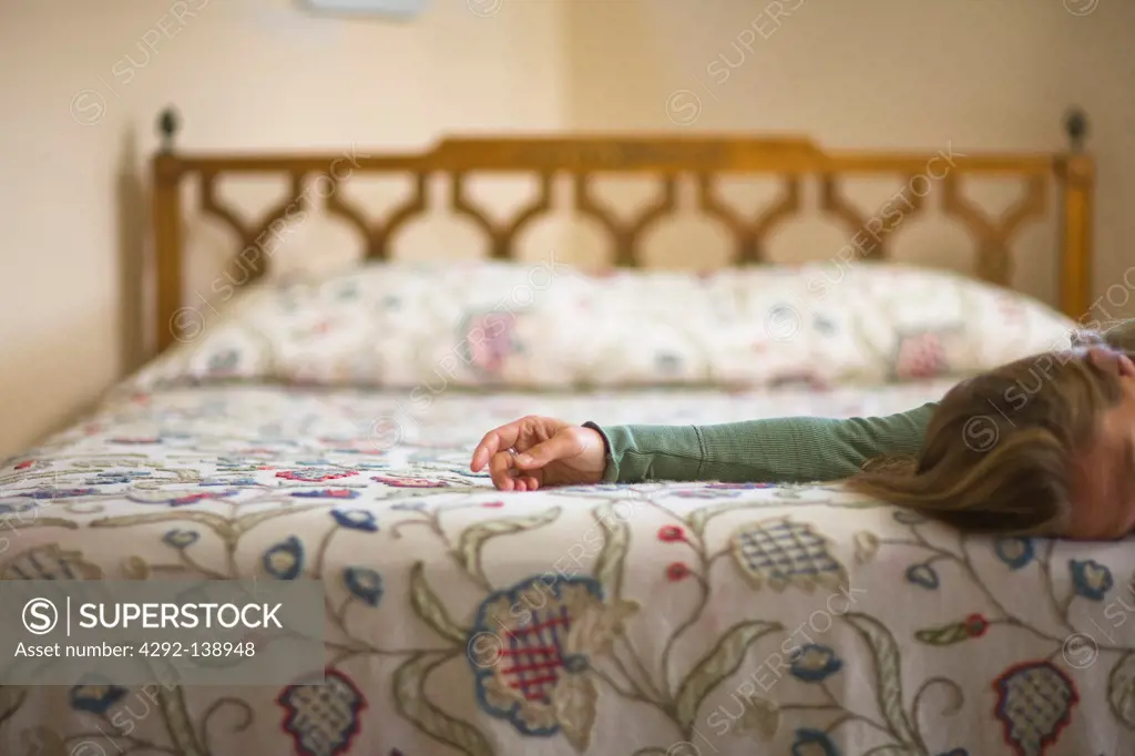 Woman kneeling by the bed