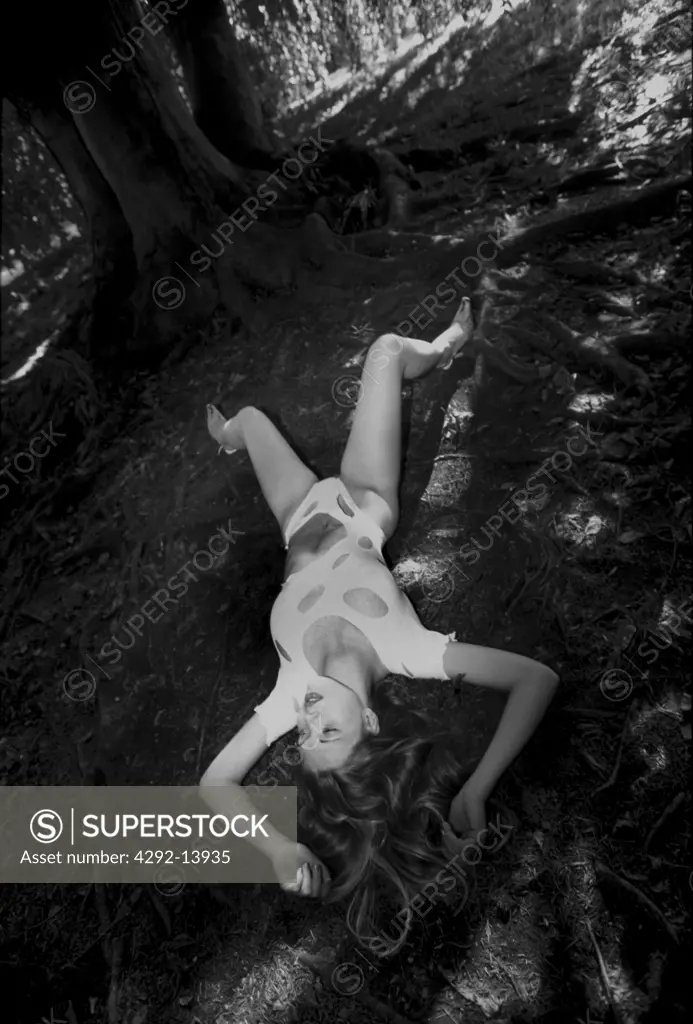 Woman lying in the grass with a ripped look body stocking