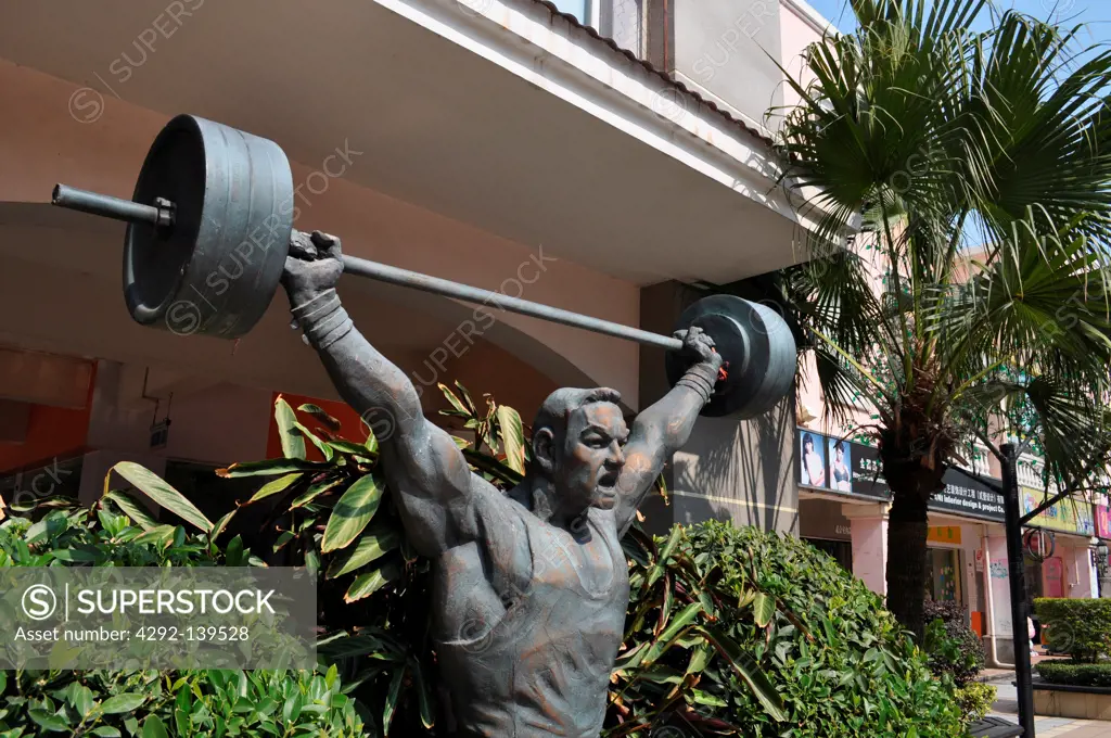 Dongguan, China, a weight lifting athlete sculpture in the Dongcheng District