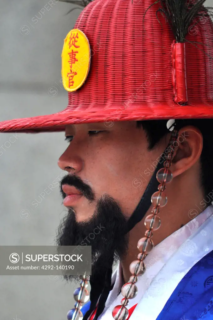 Seoul, South Korea, guard in traditional Korean outfit at the entrance of the Gwanghwamun Gate, by the Geunjeongjeon Palace