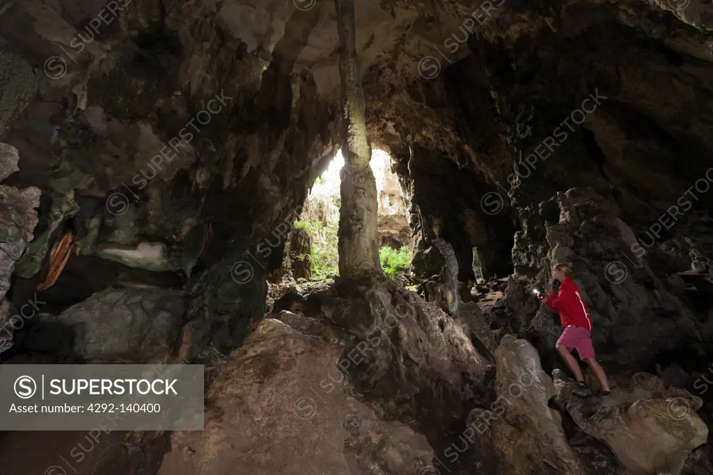 Tourist inside Kotilola Cave, Baliem Valley, West Papua, Indonesia