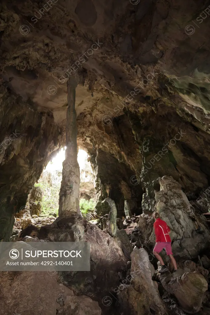 Tourist inside Kotilola Cave, Baliem Valley, West Papua, Indonesia