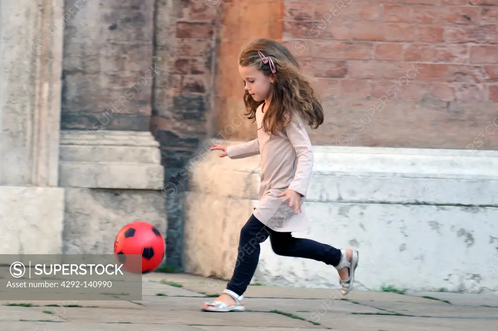 Little girl run with ball